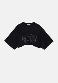 Camiseta negra corta con mangas anchas, que presenta el logo "GCDS" en strass. Hecha de suave tela de algodón con un escote redondo.