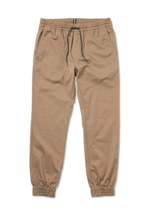 Beige jogger pants made of soft fabric, featuring an elastic waist with a drawstring, side pockets, and elastic cuffs at the ankles.