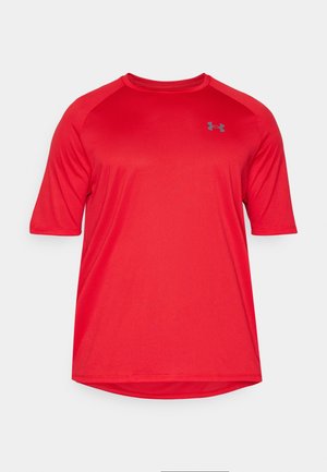 T-shirt de sport rouge à manches courtes avec des manches raglan. Fabriqué en tissu évacuant l'humidité, il présente un logo gris discret sur la poitrine.