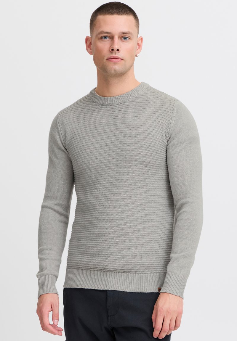 Light gray sweater with a textured ribbed design, crew neck, long sleeves, and a fitted hem. Fabric appears soft with subtle detailing.
