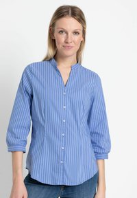 Hellblaues Button-up-Hemd mit vertikalen weißen Streifen, Mandarin-Kragen und Dreiviertelärmeln. Glattes Fabric, taillierte Passform.
