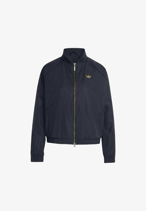 Marineblaue Jacke mit Reißverschluss, elastischen Bündchen und Saum, hohem Kragen und kleinem goldenem Adidas-Logo auf der linken Brust.