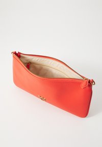 Red leather pouch with a smooth texture, tapered shape, top zipper closure, and gold-tone hardware. Lined interior with a side pocket.