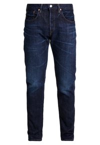 Jeans de mezclilla azul oscuro con corte ajustado, que cuentan con bolsillos delanteros, un cierre estándar con cremallera y un ligero desgastado en los muslos.