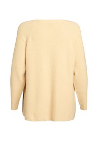 Maglione oversize giallo chiaro con motivo a coste testurizzato. Presenta una scollatura rotonda e maniche lunghe a raglan. Spacchi laterali all'orlo.