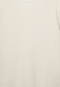 Light beige knitted sweater with a ribbed texture and a round neckline. The fabric appears soft and slightly elastic, with a plain design.