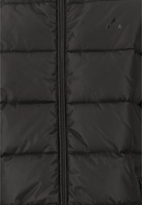 Schwarze gepolsterte Jacke mit einem Frontreißverschluss, gestepptem Design und einem minimalistischen Logo in der oberen linken Ecke. Glatte Textur und wasserabweisendes Material.