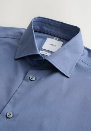 Blue cotton dress shirt with a structured collar, featuring a two-button front and a label indicating brand and fabric type.