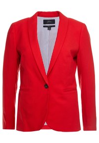 Punainen, räätälöity bleiseri, jossa on yksi musta nappi, lovetut kaulukset ja kaksi etutaskua. Vuoritettu valkoisella ja sinisellä raidallisella kankaalla.