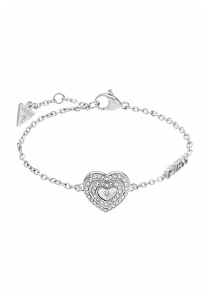 Silver chain bracelet with a heart-shaped charm adorned with crystals and a lobster clasp, featuring a small triangular logo tag.