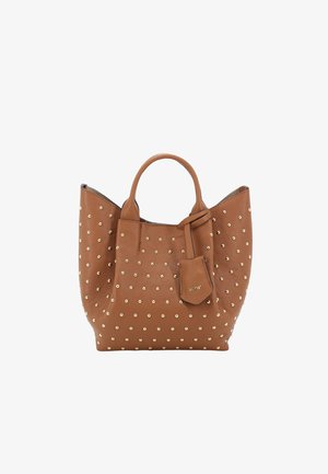 Brown leather handbag with gold studs, curved shape, dual handles, and a detachable tag; features a textured finish.