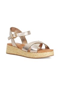 Wedge sandal with metallic crisscross straps, ankle buckle, cushioned tan insole, and braided straw platform sole.