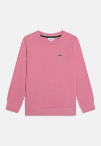 Pink sweatshirt made of soft fabric, featuring a ribbed crew neck and cuffs. Small green Lacoste logo is displayed on the front.