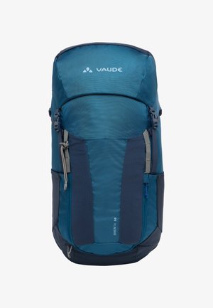 Sac à dos bleu et bleu foncé de forme cylindrique, fabriqué en tissu texturé, avec des zips, des straps réglables et un logo.