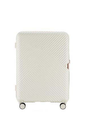 Hard-shell suitcase in off-white with a diagonal ribbed texture. Features two black wheels and rose gold accents, including zipper and logo.
