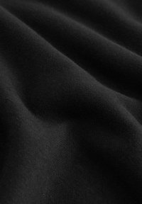 Black fabric with a smooth texture, featuring a subtle weave pattern. The material appears soft and slightly stretchy.
