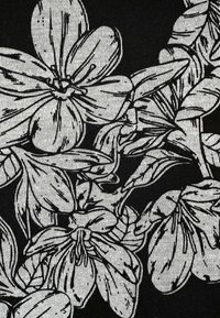 Black fabric with a white floral print pattern featuring large, detailed flowers and leaves with visible texture and shading.