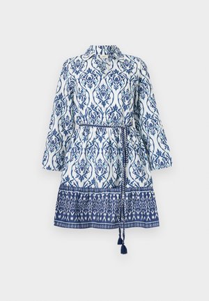 Vestido blanco con estampados florales y geométricos en azul, diseño con cuello, mangas largas, cintura ceñida y parte inferior con estampado y detalles de borlas.