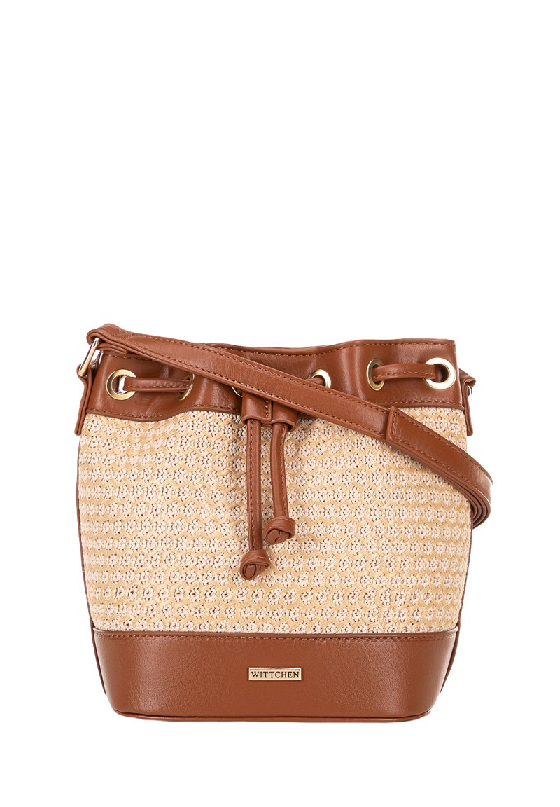 Bucket bag made of woven cream material with brown leather accents, featuring a drawstring closure and adjustable strap. Gold hardware details.