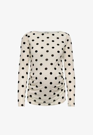 Hvit langermet ammetopp med svarte polkadotter og rynkede sider for strekk og komfort.