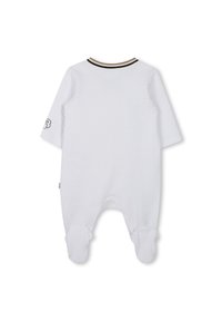 White, textured onesie with long sleeves, snap closures, and footed design. Features a black and gold collar stripe and logo on sleeve.