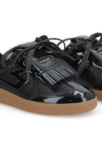 Black patent leather sneakers with textured fringe detail, round toe, and contrasting gum rubber outsole. Features black laces and a logo accent.
