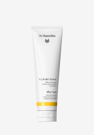 Tube de crème hydratante après-soleil Dr. Hauschka avec un emballage blanc, du texte noir et une bande jaune près du bouchon.