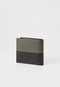 Folded wallet in black and olive green leather. Features textured finish, contrasting color blocks, and visible stitching along edges.