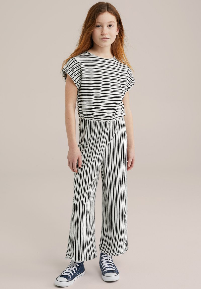 Črno-bela prugasta majica in hlače, majica s kratkimi rokavi, široke hlače, bombažni material, oblečeno z modrimi supergami.