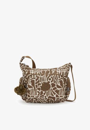 Sac à bandoulière en toile marron et crème à motifs, de forme arrondie, avec une poche frontale, une fermeture éclair et un pompon décoratif en guise de porte-bijoux.