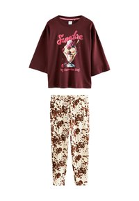 Burgundy short-sleeve t-shirt with ice cream graphic and text; cream pants with brown splotchy pattern; casual lounge set.