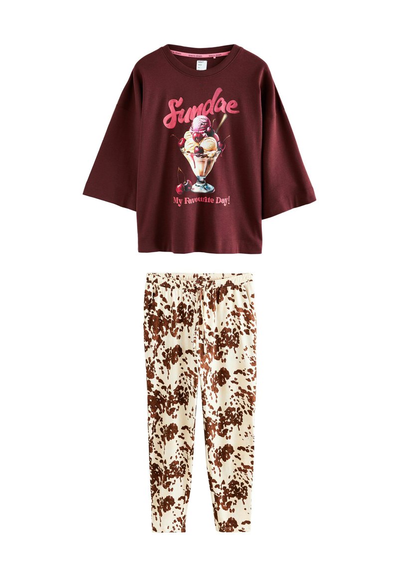 Burgundy short-sleeve t-shirt with ice cream graphic and text; cream pants with brown splotchy pattern; casual lounge set.