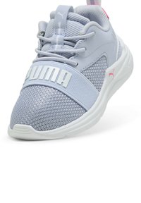 Scarpa da ginnastica blu chiaro con parte superiore in rete e sintetico, suola in gomma bianca e prominente marchio "Puma" lungo il mesopiede. Accenti rosa.