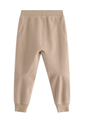 Pantaloni jogger in pile color beige chiaro con cintura a coste. Caratterizzati da tasche laterali e gambe affusolate con polsini aderenti. Texture morbida.