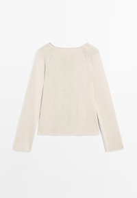 Maglione beige chiaro a maniche lunghe con scollatura rotonda, texture a costine e spacchi laterali. Presenta maniche raglan per una vestibilità rilassata.