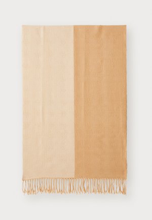 Woven throw blanket featuring a gradient color scheme from light cream to warm beige, embossed floral pattern, and fringed edges.