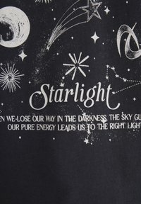 Black fabric featuring white graphic design. Includes celestial motifs like stars, moons, and a comet, with the word "Starlight" prominently displayed.