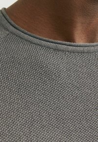 Gray knit sweater with a textured pattern, featuring a round neckline and ribbed trim along the collar. Fabric appears soft and lightweight.