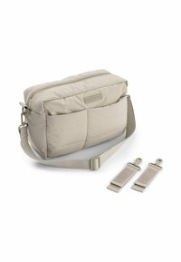 Párnázott bézs keresztpántos táska cipzáras tetejével, állítható vállpánttal és két leválasztható klipszel. Texturált felület diszkrét steppelt mintával.