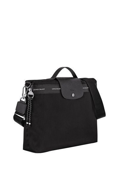 Black nylon bag with a leather flap, a top handle, and an adjustable shoulder strap. Features silver hardware and logo detailing.