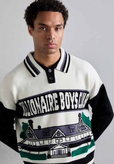 Pull en tricot crème, noir et vert. Présente un graphique de maison et "Billionaire Boys Club" en texte gras. Col côtelé avec boutons.