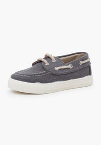 Grauer Canvas Sneaker mit weißer Gummisohle, runden Zehen und beigen Schnürsenkeln. Verfügt über gestickte Details und Metallösen für die Schnürsenkel.