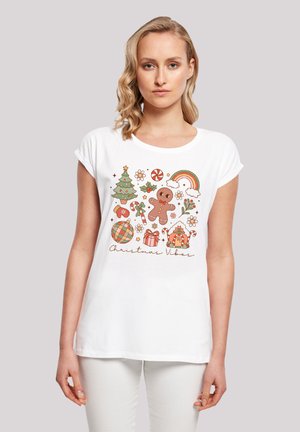 White short-sleeve T-shirt featuring a colorful Christmas-themed graphic with a gingerbread man, decorations, and the text "Christmas Vibes."