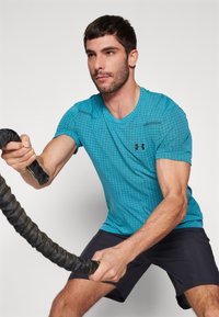 Under Armour VANISH SEAMLESS GRID - Sportovní tričko - circuit teal/black