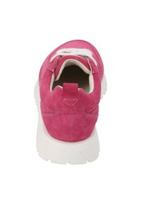 Pink suede sneaker with white laces and a cushioned sole; features a tab at the heel and stitching details on the sides.