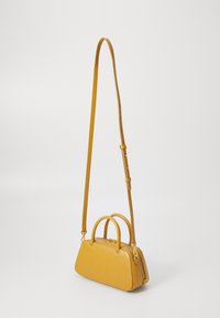 Yellow leather handbag with a structured design, top handles, and a detachable shoulder strap. Features a zip closure and gold hardware accents.