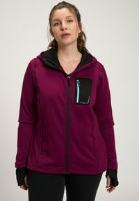Veste à capuche zippée en polaire de couleur violet vif avec des accents noirs, dotée d'une poche avant, de trous pour les pouces et de détails de zip contrastants.