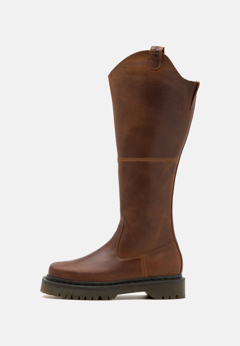 Brown leather knee-high boot with a rounded toe, textured upper, sturdy rubber sole, and a pull tab at the top for easy wear.