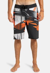 Black board shorts featuring bold orange, white, and grey geometric patterns. Made of lightweight material with a drawstring waist.