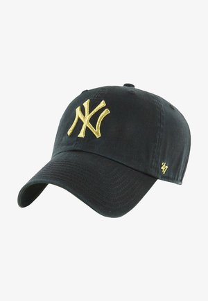 Black cap made of cotton with a curved brim. Features an embroidered gold New York Yankees logo on the front and a small logo on the side.
